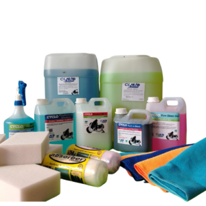 Assorted cleaning products including spray bottle, large detergent jugs, sponges, and microfiber cloths on a white background